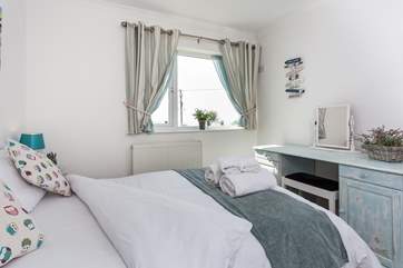 Bedroom 3 is furnished in beautiful pastel colours.