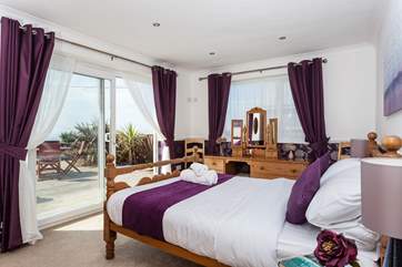 Bedroom 1 has patio doors which take you out onto the deck and garden, and the sea views!