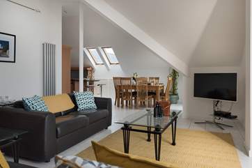 The sitting area leads through to dining and cooking areas.