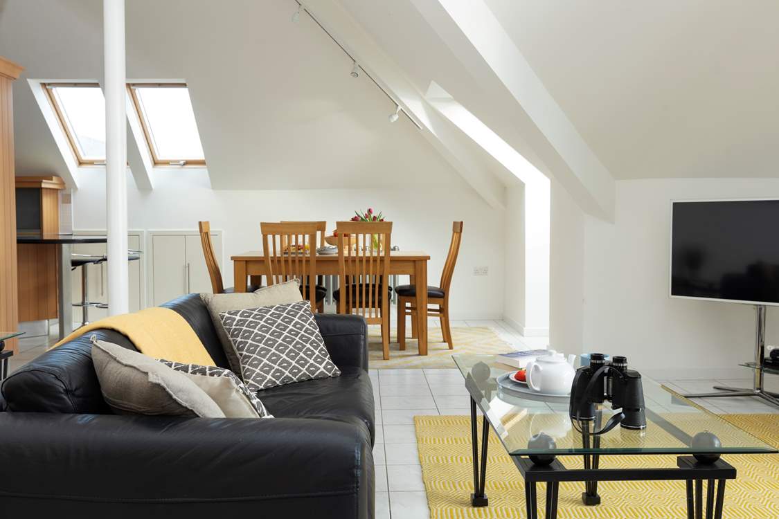 The sitting area leads to the dining area and kitchen.