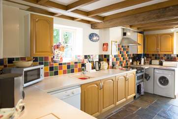 Back downstairs the kitchen is really well-equipped. It opens onto a very sheltered enclosed patio.