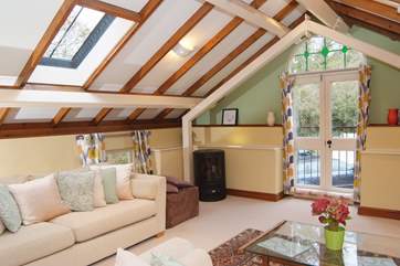 This is the spacious first floor sitting-room with a Juliette balcony overlooking the patio and towards the tennis court.