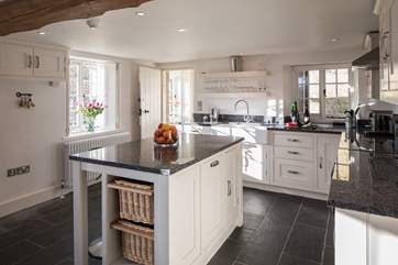 This well-equipped kitchen has everything you could need, the cloakroom and the back door are at the far end.