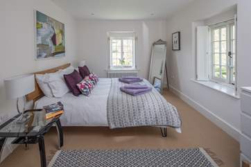 The master bedroom (bedroom 1), with comfy 5ft bed, en suite shower-room and great views over the valley. There is plenty of space for a travel cot.