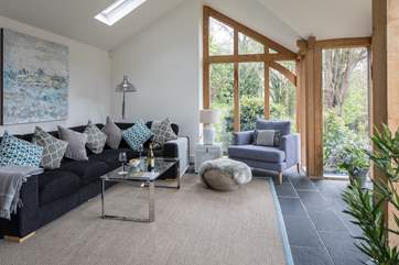 The vaulted sitting-room has a green oak and glass front, giving views of the garden from the comfort of the sofa.