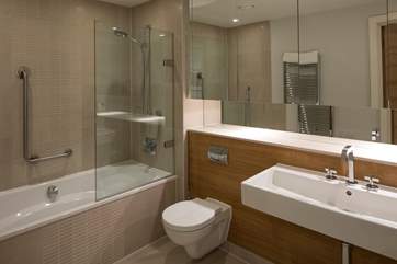 The main bathroom offers a bath, shower and the most gigantic mirror with endless storage space for all your personal toiletries.