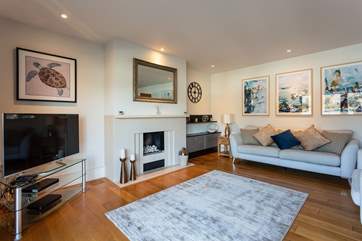 The sitting-room, perfect for relaxing with a glass of something tasty. Please note the pebble effect fireplace is decorative.