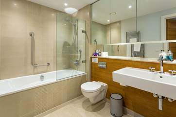 The main bathroom offers a bath, shower and the most gigantic mirror with endless storage space for all your personal toiletries.
