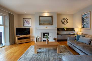 The sitting-room, perfect for relaxing with a glass of something tasty. Please note the pebble effect fireplace is decorative.