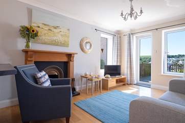 The open plan living-room has a door out to a deck with far-reaching views.