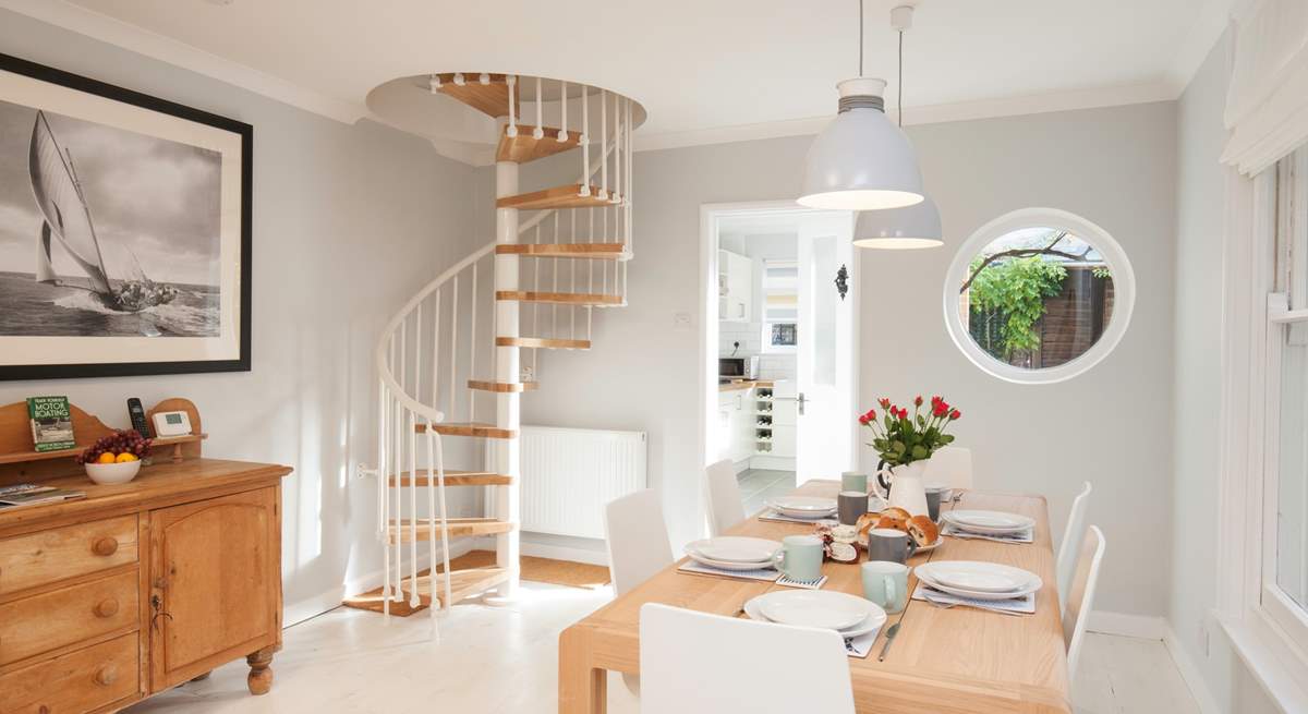 The spiral staircase is a beautiful feature in the  sitting/dining-room.