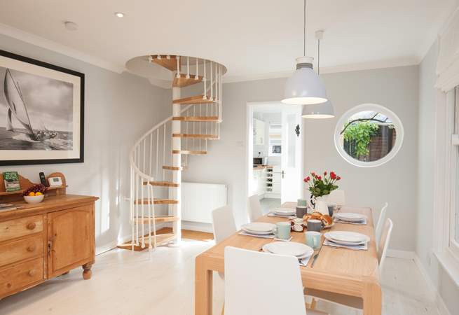The spiral staircase is a beautiful feature in the  sitting/dining-room.