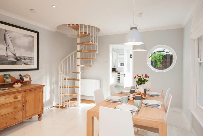 The spiral staircase is a beautiful feature in the  sitting/dining-room.