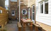 The delightful rear patio is perfect for al fresco dining. - Thumbnail Image