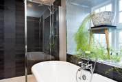 The bathroom not only has a beautiful roll-top  bath but also has a large drench-head shower.