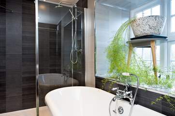 The bathroom not only has a beautiful roll-top bath but also has a large drench-head shower.
