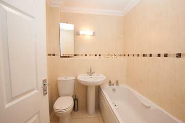 One of the three bathrooms; enjoy a relaxing soak or bath the little ones after a long day at the beach.