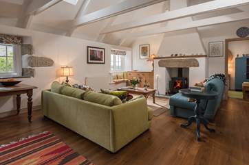 Cosy sitting-room with comfy sofas and wood-burner. There is a good selection of books to read and games to play.