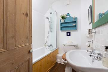 The family bathroom has a bath and over head shower.