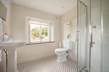 The large shower-room has wonderful countryside views and the original windows - a lovely feature to add to the quirkiness of this unique retreat.