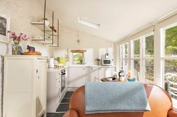 The delightful living area includes a well-equipped kitchen as well as a sitting and dining-area, the perfect social space.