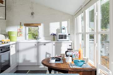 The sun shines through the windows into this lovely room.