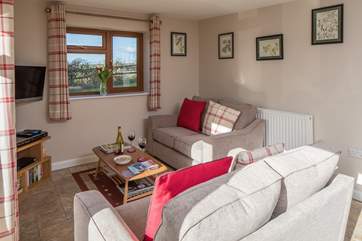 The cosy sitting-area looks out over open countryside.