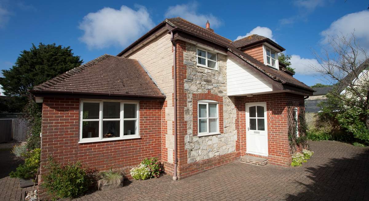 There is plenty of private parking here at The New House. The windows and front door are now grey.  New exterior photos to come in 2024.