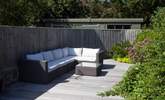 As the sunshine fills the garden, relax on one of many seating options outside. - Thumbnail Image