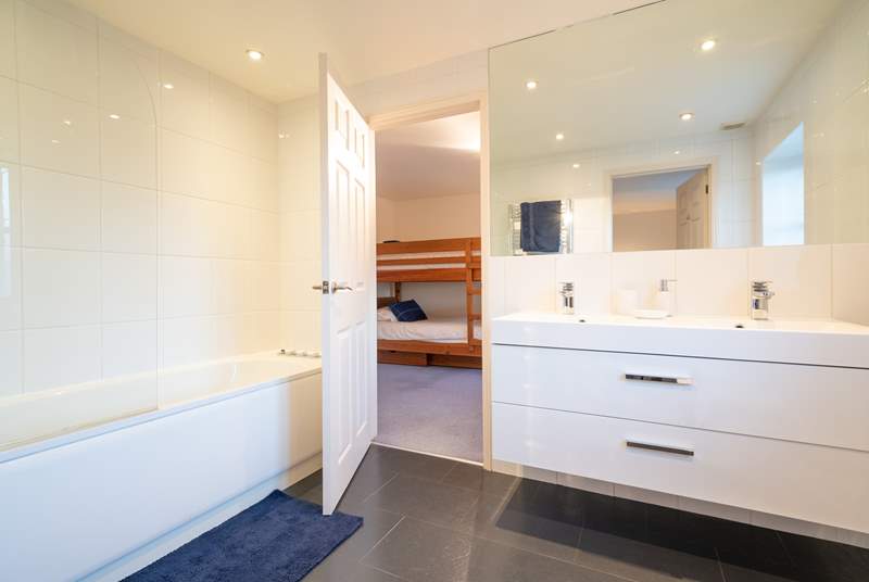 The Jack and Jill bathroom with bath, fitted shower and double sink.