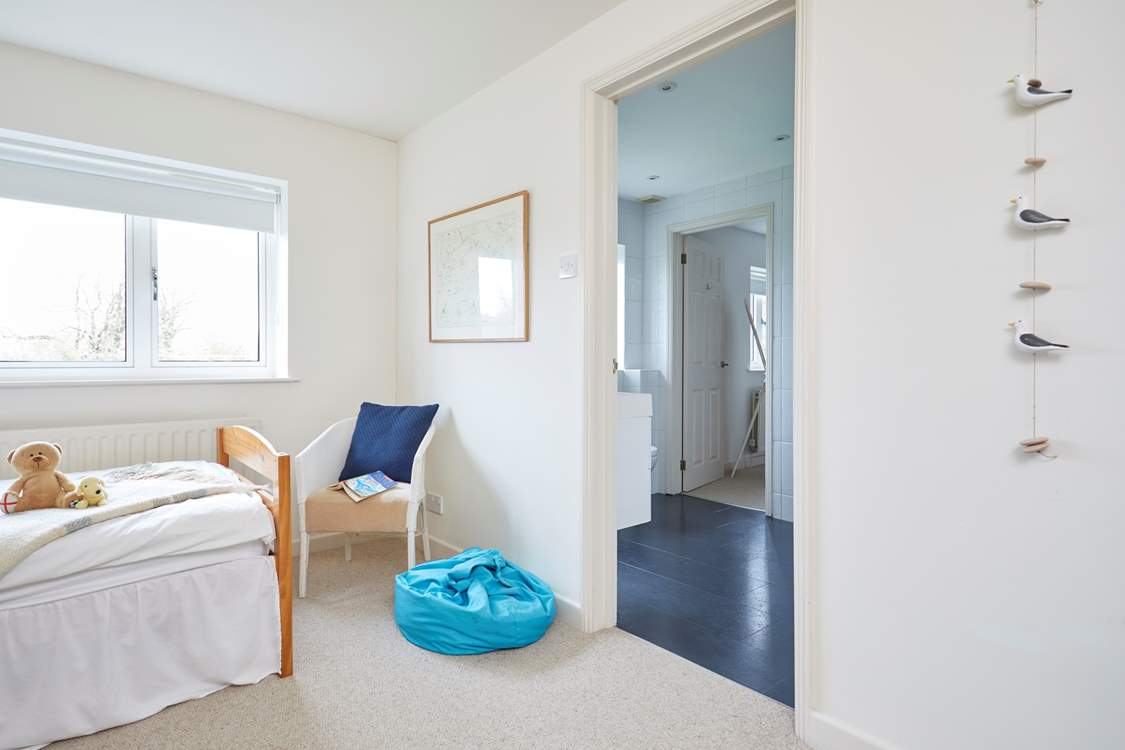 The children's bedroom leading through to the shared bathroom.
