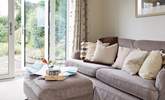 Relax on the deep sofa with plenty of scatter cushions, plan your day ahead with the local map. - Thumbnail Image