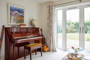 The sun-room with many musical instruments leads out to the stunning garden.