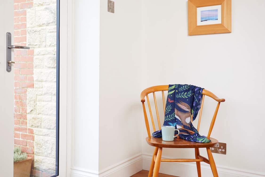 The corner chair in the dining area is a great seat to observe the activities around the table.