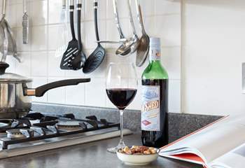 Enjoy a glass of red while preparing a local recipe.
