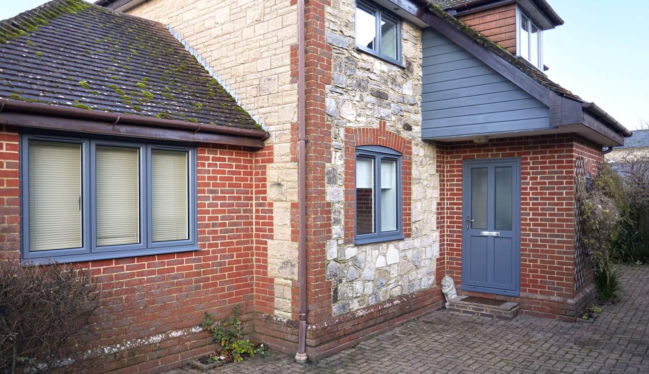 Welcome to the New House with the recently replaced front door and windows in grey. 