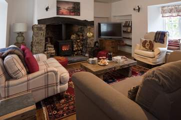 The main sitting-room boasts a fabulous wood-burner. Ideal for snuggling up and getting cosy.