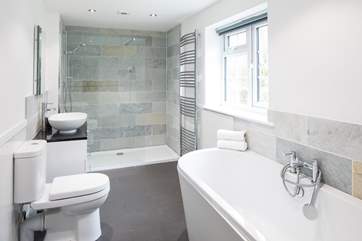 En suite to the master bedroom has a large bath and even larger walk-in shower.