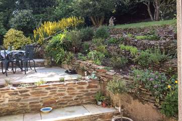 The colourful and lovingly maintained garden is set over many tiers. Please be careful when enjoying the garden due to the tiered design and landscape.