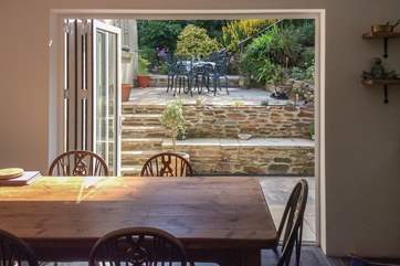 Swing open the bi-fold doors and step out of the kitchen onto the patio. Such a great space for dining al fresco.