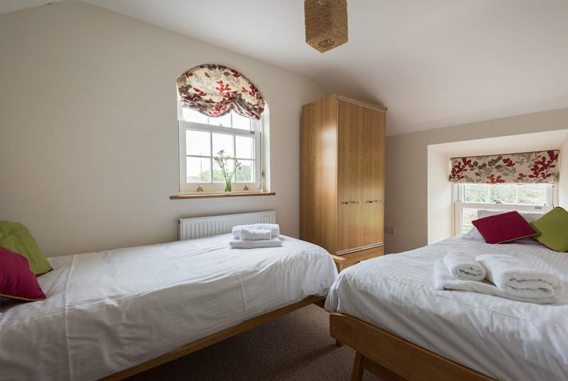 The dual-aspect twin bedroom is at the end of the hall, across the landing from the other bedrooms.