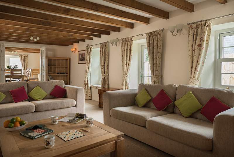 There are two sofas around the wood-burner and at the other end of the sitting-room.