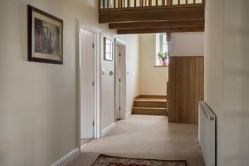 The entrance hallway with the twin bedroom and kitchen to the left, and sitting and dining-room to the right. Head straight upstairs to the bedrooms.