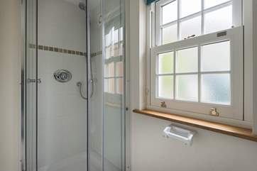 The shower cubicle and loo are separate from the wash-basin.