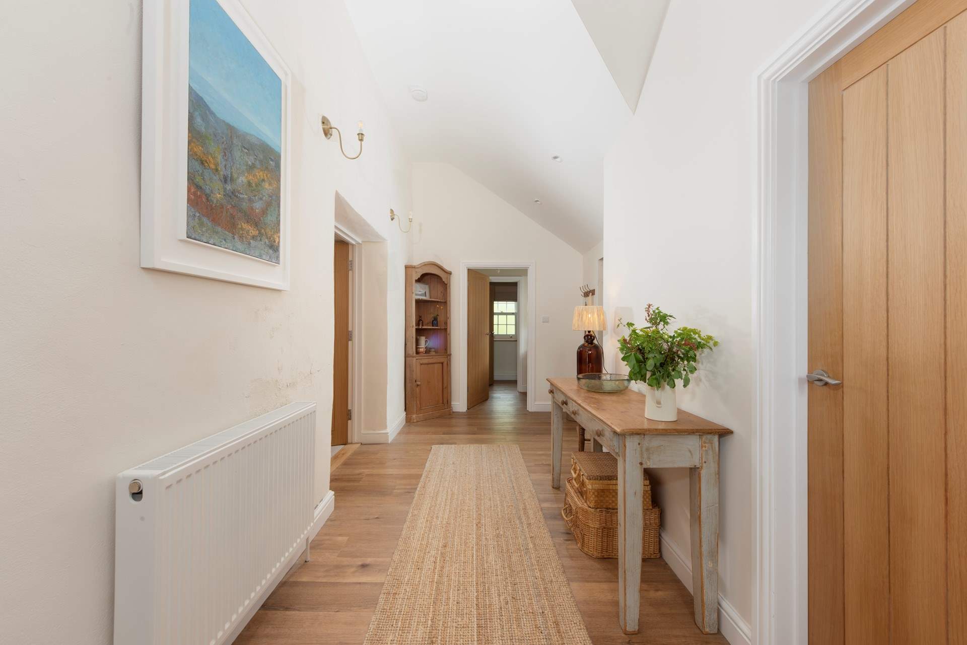 The ground floor entrance hall with a practical shower-room at the end.