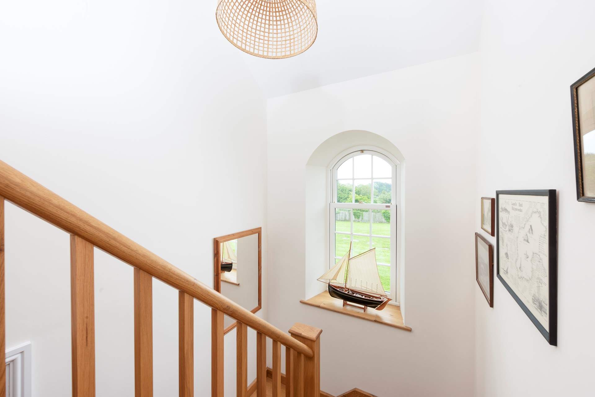 The arched window frames the stairway. 