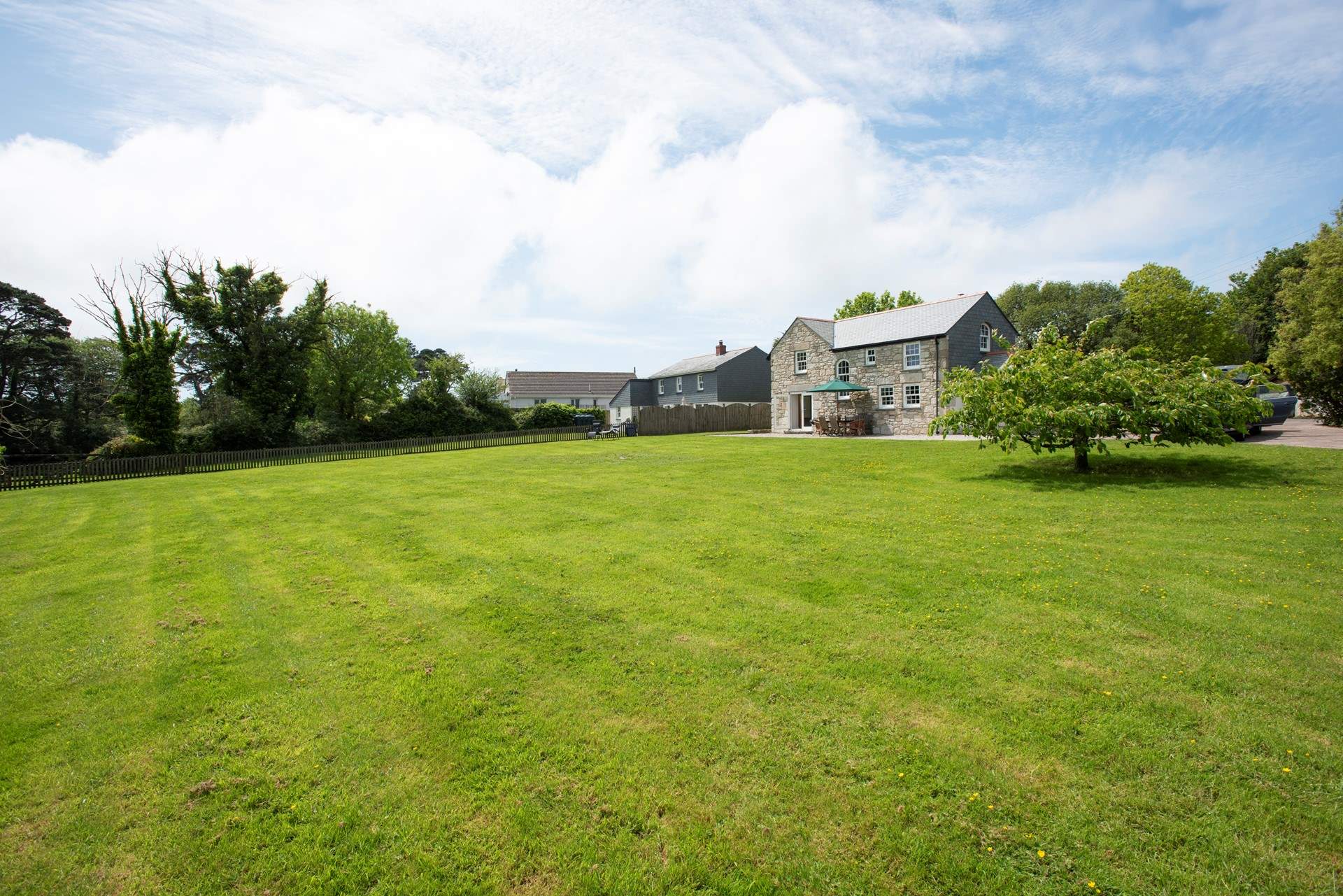 The enclosed garden has an expansive lawn for family games.