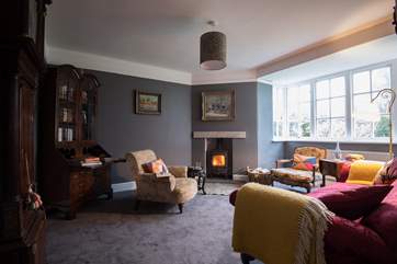 The snug sitting-room has a cosy wood-burner.
