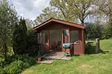 The summer-house faces south and looks over the garden - a real sun trap and perfect spot for a barbecue.
