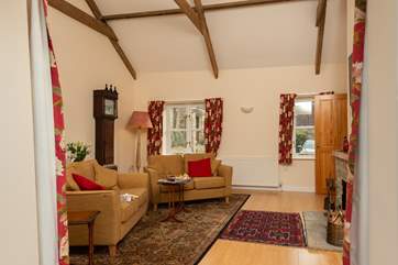 Looking into the sitting-room from the French doors. Your parking is right outside the front of the cottage. The owner's farmhouse is seen to the left.